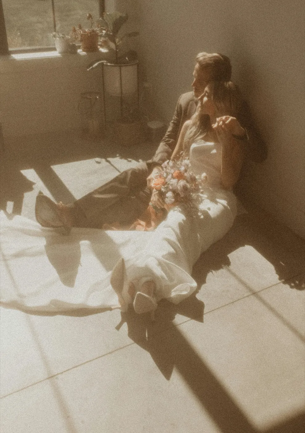 A couple resting on the floor in hazy afternoon light